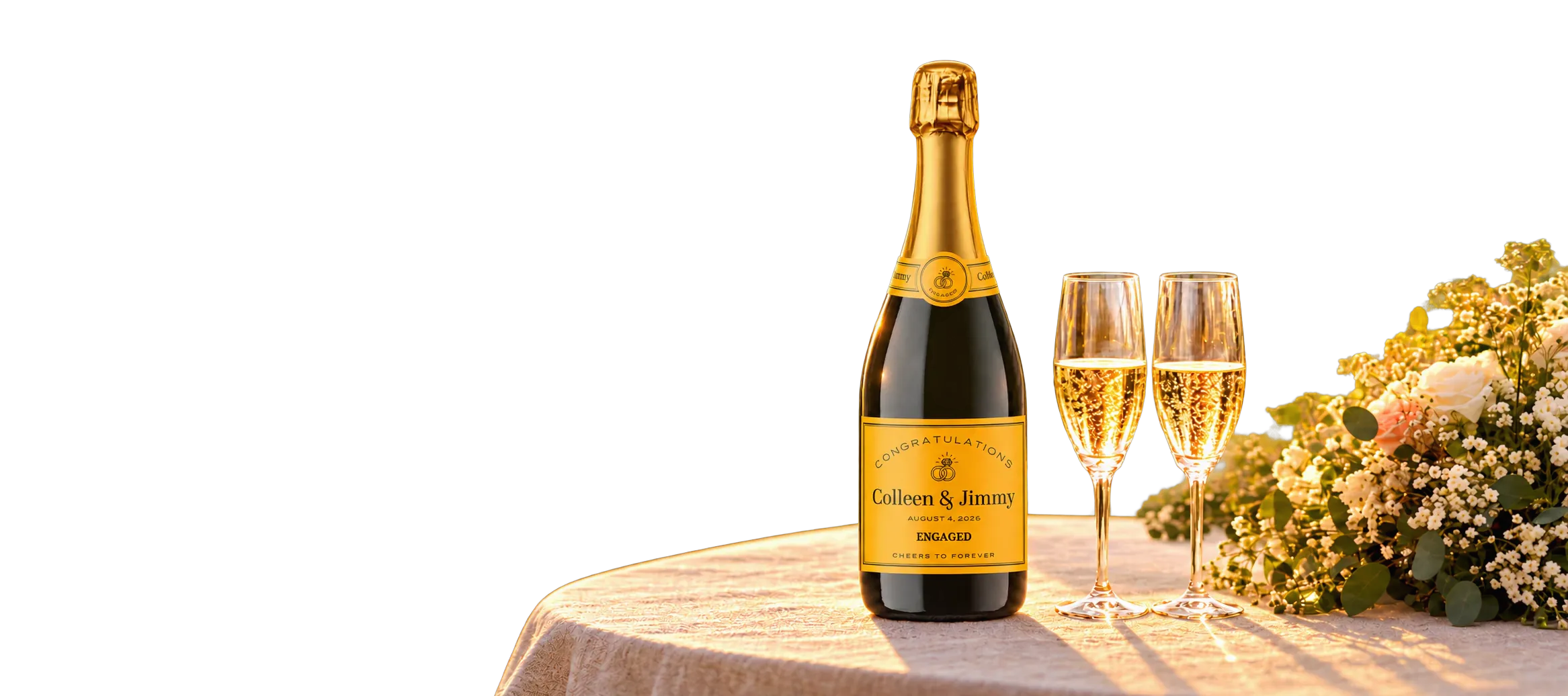 Champagne bottle with a personalized engagement label on a sunlit garden table, a couple celebrating behind it